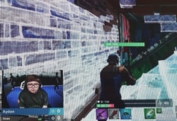 FILE - A contestant competes during the Fortnite World Cup Duos Finals in the Queens borough of New York, July 27, 2019.