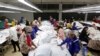 FILE - Employees work at a garment factory in Kandal province, Cambodia, Dec. 12, 2018. 