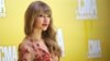Taylor Swift arrives at the 46th Annual Country Music Awards at the Bridgestone Arena on Thursday, Nov. 1, 2012, in Nashville, Tenn.