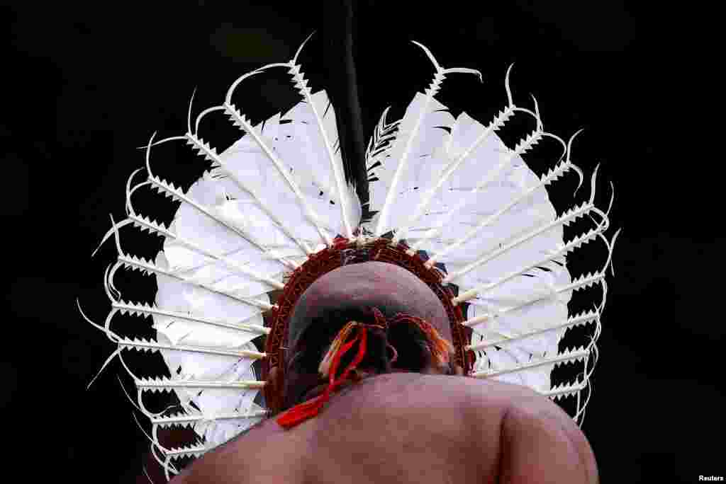An indigenous man from the Torres Strait Islands wears traditional garb as he performs during a welcoming ceremony at Government House in Sydney, Australia.