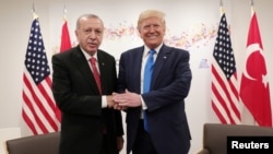Turkey's President Tayyip Erdogan shakes hands with U.S. President Donald Trump during their bilateral meeting on the sidelines of the G20 leaders summit in Osaka, Japan, June 29, 2019. 