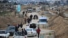 Displaced Palestinians cross the Netzarim corridor as they make their way to the northern parts of the Gaza Strip on February 9, 2025.