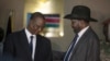 South Sudan's First Vice President Taban Deng Gai, left, speaks with President Salva Kiir, right, after Taban was sworn in, replacing opposition leader Riek Machar, at the presidential palace in Juba, South Sudan, Tuesday, July 26, 2016.