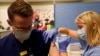 La paciente de coronavirus Joan Bronson cruza su habitación del hospital con la ayuda de un fisioterapeuta en Ochsner Medical Center en el suburbio de Jefferson, Luisiana, el 11 de agosto de 2021.