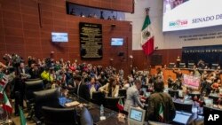 Protesters break into a Senate session in which lawmakers were debating the government's proposed judicial overhaul, which would make judges stand for election, in Mexico City, Sept. 10, 2024. The plan passed early Sept. 11 and now must be ratified by state legislatures.