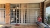 A man sits outside the closed Isizinda Sempilo clinic in the Johannesburg township of Soweto Thursday, Jan. 30, 2025. (AP Photo/Alfonso Nqunjana)