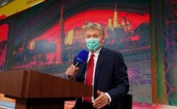Kremlin spokesman Dmitry Peskov speaks to journalists prior to a video call in news conference of Russian President Vladimir Putin on Dec. 17, 2020.