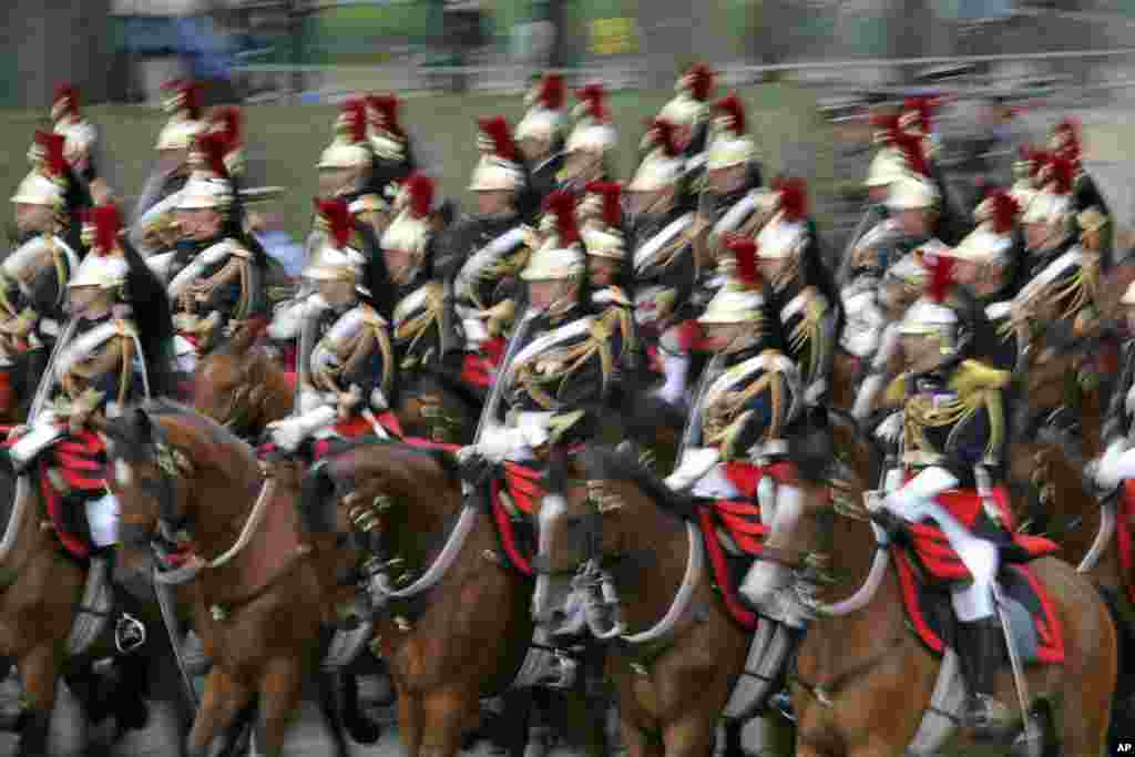 French Republican Guards ride in the parade during the traditional Bastille Day celebrations, on the Champs-Elysees, in Paris, July 14, 2014.