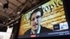 FILE - NSA whistleblower Edward Snowden speaks via videoconference at the "Virtual Conversation With Edward Snowden" during the 2014 SXSW Music, Film + Interactive Festival at the Austin Convention Center, March 10, 2014.
