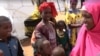 Abdiya Golicha, wearing pink, lives in northern Kenya's Marsabit County and volunteers to help Ethiopian refugees at the Dambala Fachana camp. (D. Gelmo/VOA)