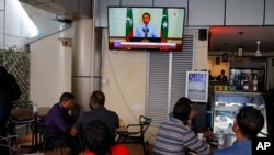 Maldivian watch a live telecast of statement delivered by outgoing President Yameen Abdul Gayoom at a cafe in Male, Sept. 24, 2018.