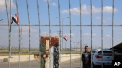 FILE - An employee of the Palestinian Authority stands guard on the Palestinian side of the Erez checkpoint between Israel and Gaza, at Beit Hanoun, Gaza Strip, Nov. 1, 2017.