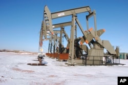 FILE - This Feb. 26, 2015, file photo, shows an oil well on the Fort Berthold Indian Reservation near Mandaree, North Dakota.