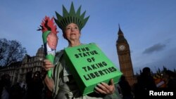 A demonstrator dressed as the Statue of Liberty takes part in a protest against U.S. President Donald Trump in London, Feb. 20, 2017.