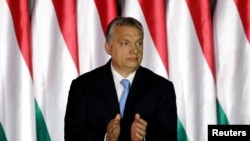 FILE - Hungarian Prime Minister Viktor Orban applauds at an event in Budapest, Hungary, April 5, 2019.