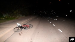 FILE - Image provided by the Tempe Police Department shows the scene where an an Uber SUV hit a woman in Tempe, Ariz on March 18, 2018.