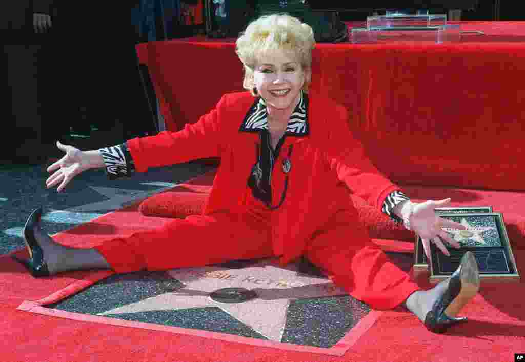 Stage and film actress Debbie Reynolds poses with her second star on the Hollywood Walk of Fame, Jan. 13, 1997, in the Hollywood section of Los Angeles.