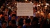 A man holds up a sign saying Arab Muslims condemn the attack as he takes part in a candlelight memorial service after a mass shooting at the Pulse nightclub in Orlando, Florida, June 13, 2016.
