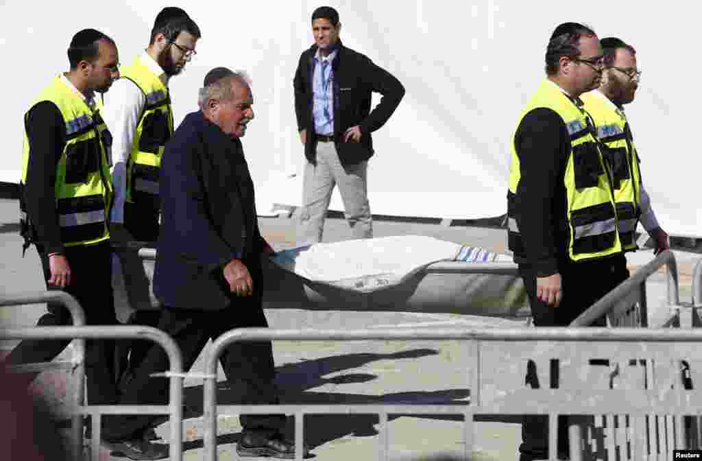 The covered body of one of the victims of an attack on a Paris grocery on Friday is carried at a joint funeral in Jerusalem, Jan. 13, 2015.