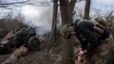 A Ukrainian serviceman of the Khartia brigade fires an M101 Howitzer toward Russian positions in Ukraine's Kharkiv region, March 12, 2025.