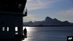 FILE - Personnel stand aboard the Finnish icebreaker MSV Nordica as it arrives into Nuuk, Greenland, after traversing the Northwest Passage through the Canadian Arctic Archipelago, July 29, 2017.