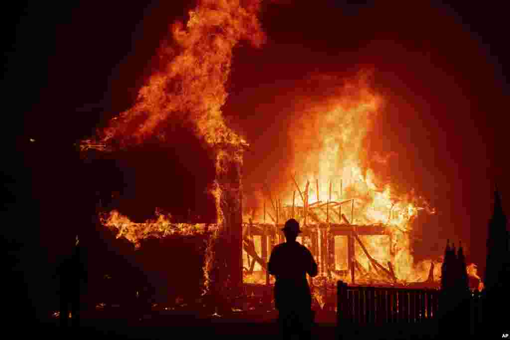 A home burns as the Camp Fire rages through Paradise, Calif., on Nov. 8, 2018.