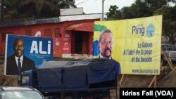 Les affiches de la campagne électorale du président gabonais sortant Ali Bongo et de son rival Jean Ping de l’opposition, sont côte-à-côte, à Libreville, 26 août 2016. VOA/Idriss Fall 