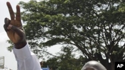 Ivory Cost President Laurent Gbagbo, shows a peace sign at a rally in Abidjan, 26 Nov 2010