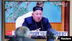 FILE - People watch a TV broadcasting a news report on North Korean leader Kim Jong Un in Seoul, South Korea, April 21, 2020.