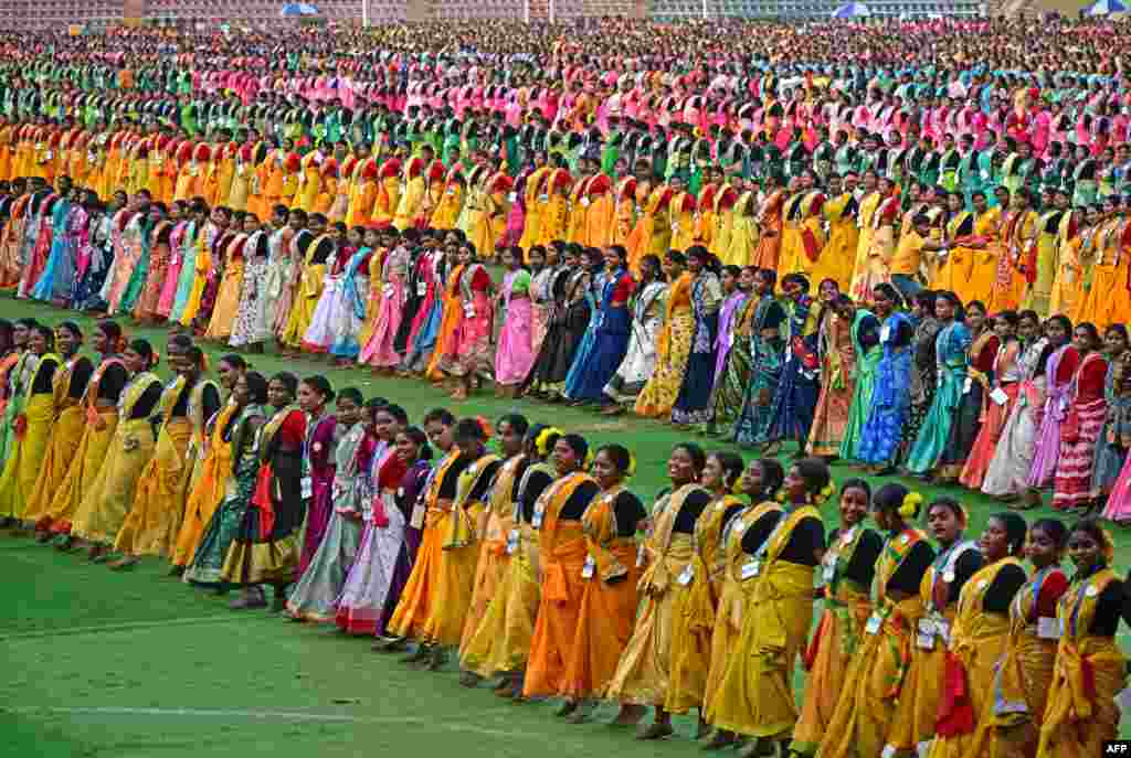 Thousands of dancers perform "jhumur," an Indian folk dance, as they rehearse for the upcoming Jhumur Festival at the Sarusajai Stadium in Guwahati, India. (Photo by Biju BORO / AFP)