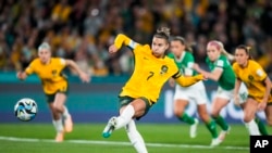 Australia's Steph Catley shoots a penalty kick to score the opening goal during the Women's World Cup soccer match between Australia and Ireland at Stadium Australia in Sydney, Australia, Thursday, July 20, 2023. (AP Photo/Rick Rycroft)