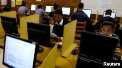 FILE - Students use computers to study at Elswood Secondary School in Cape Town, Nov. 7, 2013. 
