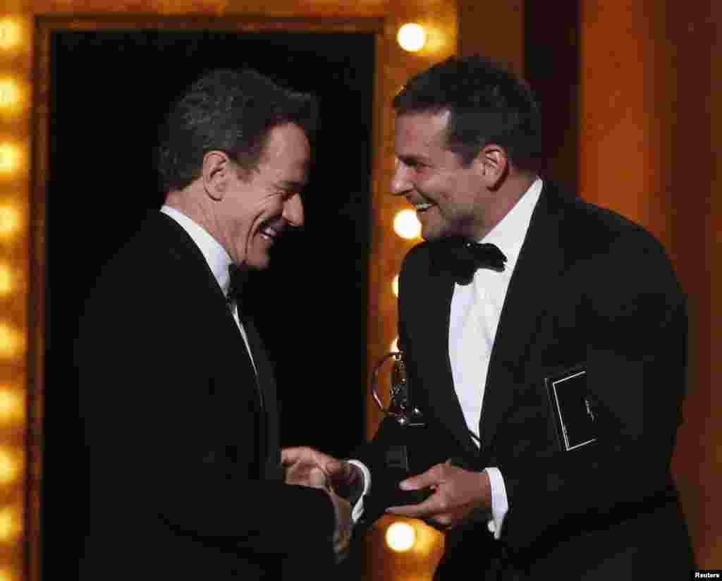 Bradley Cooper (right) presents Bryan Cranston with the Award for Best Performance by an Actor in a Leading Role in a Play for "All The Way" during the American Theatre Wing's 68th annual Tony Awards at Radio City Music Hall in New York, June 8, 2014.