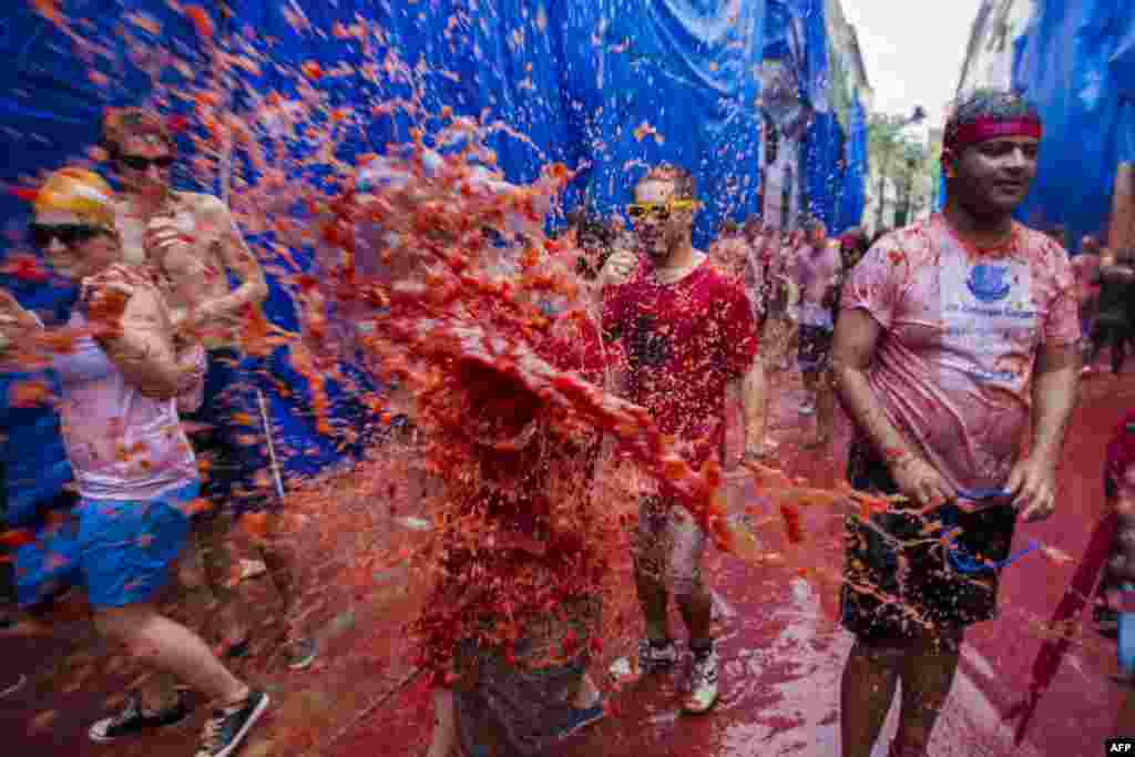 Warga setempat bersuka ria mengambil bagian dalam perayaan tahunan "Tomatina" di Bunol, dekat Valencia, Spanyol.