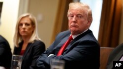 President Donald Trump listens during a meeting with law enforcement officials on the MS-13 street gang and border security, in the Cabinet Room of the White House, Feb. 6, 2018.