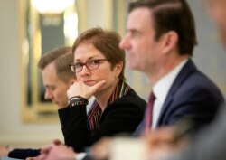 FILE - U.S. Ambassador to Ukraine Marie Yovanovitch, center, attends a meeting with Ukrainian President Petro Poroshenko in Kyiv, Ukraine, March 6, 2019.