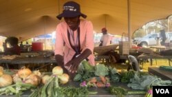 Widows displaying their farm produce and other items at an agricultural event in Victoria Falls