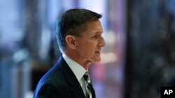FILE - Michael Flynn walks through the lobby at Trump Tower in New York, Nov. 17, 2016. 
