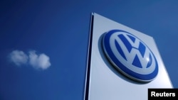 FILE - A Volkswagen logo rises at a newly opened Volkswagen factory in Wrzesnia, Poland, Sept. 9, 2016. 