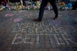 A man walks past a memorial for those killed in a mass shooting in Dayton, Ohio, Aug. 7, 2019.