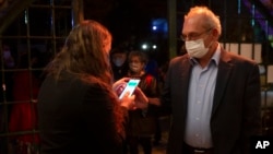A man presents his "green passport," proof that he is vaccinated against the coronavirus, on opening night at the Khan Theater in Jerusalem. (AP Photo/Maya Alleruzzo)