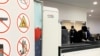 FILE - Passengers walk next to Nuctech security scanners at the Brussels Eurostar train terminal on Monday, Jan. 17, 2022. 
