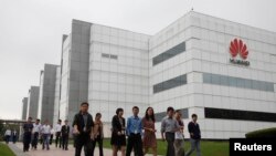 華為技術有限公司的員工走過廣東省深圳市的公司辦公樓（2012年4月17日）。