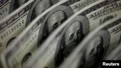 FILE PHOTO: A picture illustration shows U.S. 100 dollar bank notes taken in Tokyo