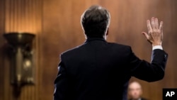 Supreme Court nominee Judge Brett Kavanaugh is sworn in by Chairman Chuck Grassley, R-Iowa, before testifying during the Senate Judiciary Committee on Capitol Hill in Washington, Sept. 27, 2018. 