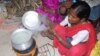 FILE - A woman in India is uses a cookstove that produces less smoke for burning wood or any other fuel. 