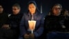 A woman holds a candle as Cardinal Robert Francis Prevost, Prefect of the Dicastery for Bishops, leads the recitation of the Holy Rosary for Pope Francis' health in St Peter's Square at the Vatican, March 3, 2025. 