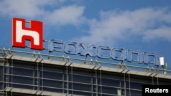 FILE - The logo of Foxconn, the trading name of Hon Hai Precision Industry, is seen on top of the company's building in Taipei, Taiwan.