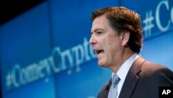 FBI Director James Comey speaks about the impact of technology on law enforcement, Thursday, Oct. 16, 2014, at Brookings Institution in Washington. Comey gave a stark warning against smartphone data encryption, saying homicide cases could be stalled, suspects could go free and “justice may be denied because of a locked phone or an encrypted hard drive.” (AP Photo/Jose Luis Magana)