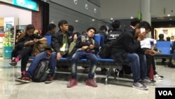 FILE - Cambodian workers at Phnom Penh International Airport waiting to board a plane to Seoul, South Korea. 